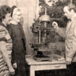 old photo of people using a machine