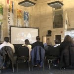 people watching a projector screen