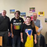 six people standing in a room