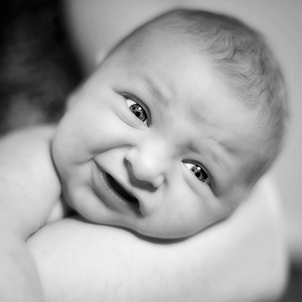 Cradled infant glances upwards